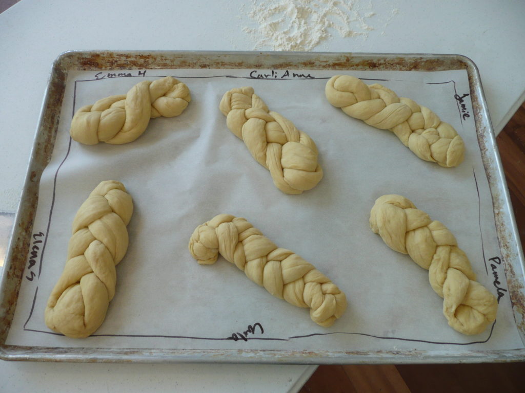 Challah braided by study tour participants awaits baking.