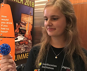 Carolina senior Sam Petrie shows visitors a scaled-up model of a 3D-printed product that shows detailed structures that can be created with new additive manufacturing technologies.