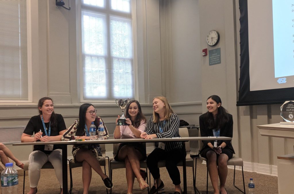 Students at Kent Place School in New Jersey won the sixth annual National High School Ethics Bowl. Students are pictured here sitting at a table with their trophy.