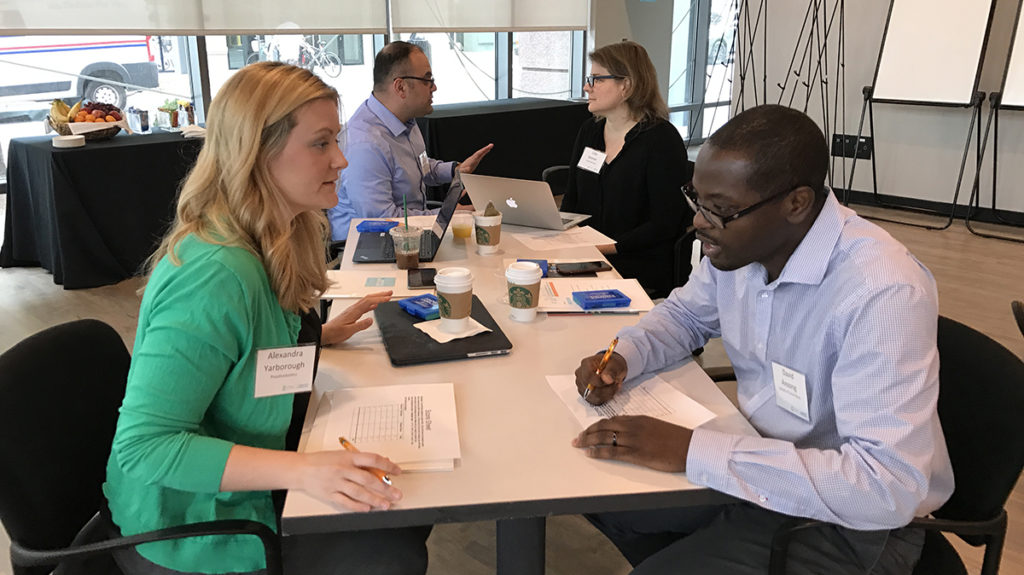 UNC Faculty Entrepreneurship Workshop participants Alex Yarborough (School of Dentistry) and David Ansong (School of Social Work) discuss ideas during the workshop.