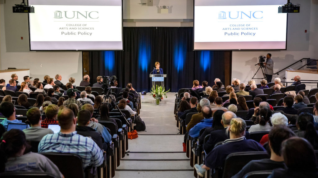 Mary Sue Coleman delivered the Thomas Willis Lambeth Distinguished Lecture in Public Policy. (photo by Johnny Andrews). She is shown here giving a lecture at t podium to the audience in Hamilton Hall auditorium.