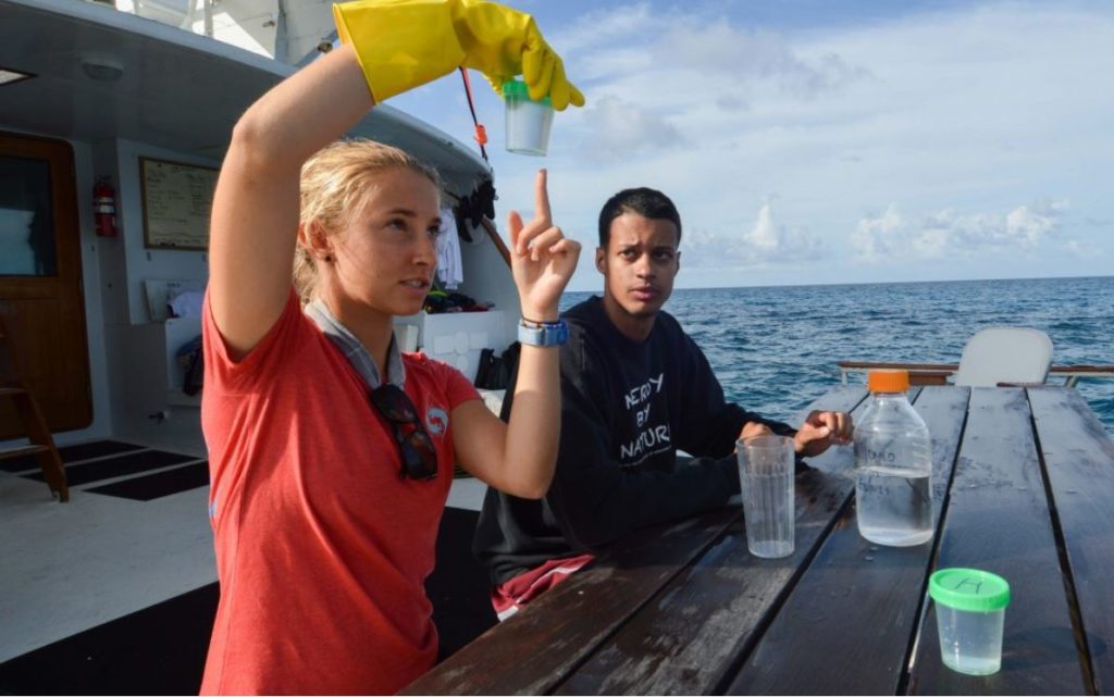 Liah McPherson on a boat with another person doing research.