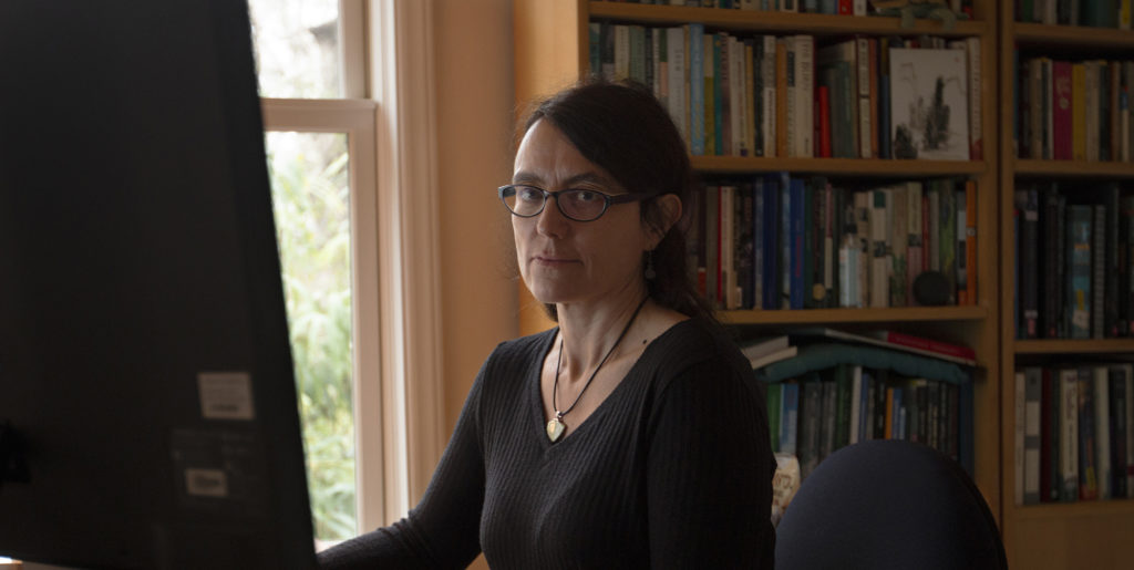 Julia Haslett, a documentary filmmaker and assistant professor of communication, edits her films in her home office in Carrboro, North Carolina. (photo by Alyssa LaFaro)