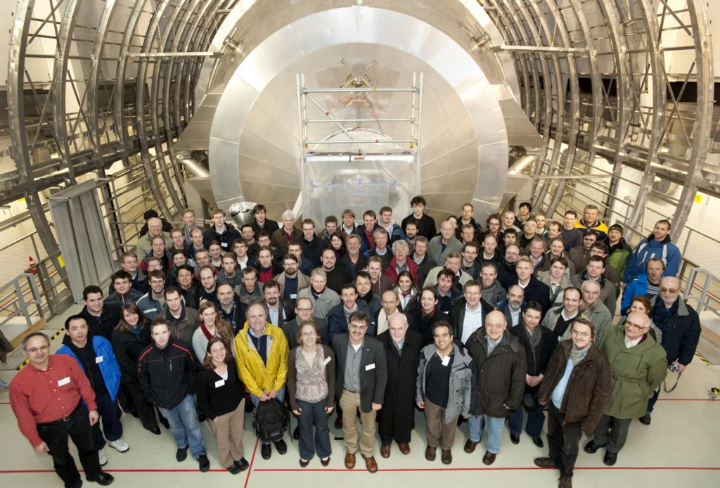 In this 2010 image, members of the KATRIN experiment pose in front of the spectrometer after it was installed at the Karlsruhe Institute of Technology. (photo by Joachim Wolf/Karlsruhe Institute of Technology)