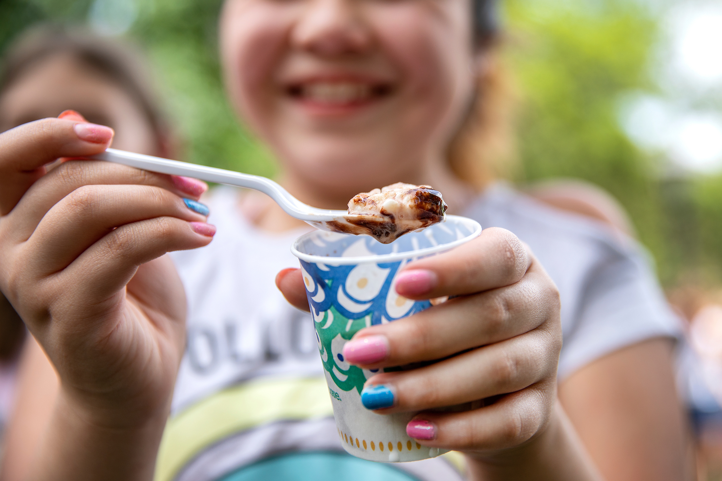 Participants capped off the day by enjoying a scoop of ice cream made with liquid nitrogen. (photo by Johnny Andrews) A student is shown here with a closeup of a cup of icecream.