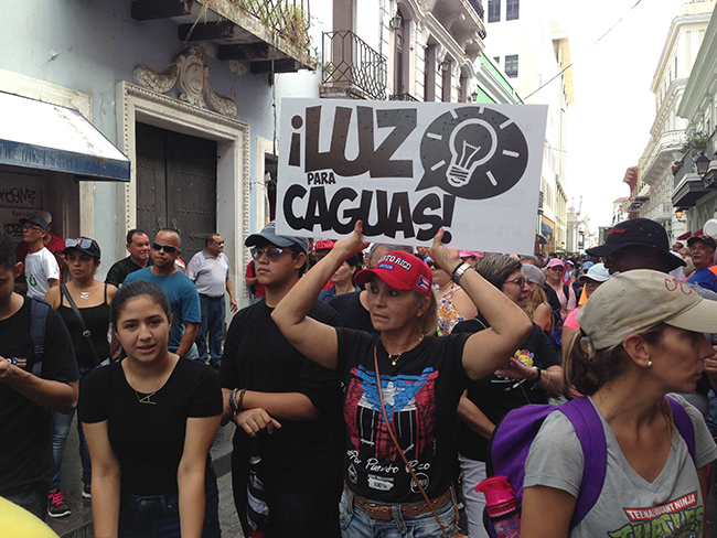 From Sandy Smith: Nonini: photo of folks holding signs: In July, I went to Puerto Rico with my son, filmmaker Roque Nonini. We’re making a documentary called Dis.em.POWER.ed: Puerto Rico’s Perfect Storm about the long (and for some, ongoing) blackout after Hurricane Maria. We’ll distribute it free to educators and nonprofits.