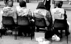 Electoral officials wait to check in voters.