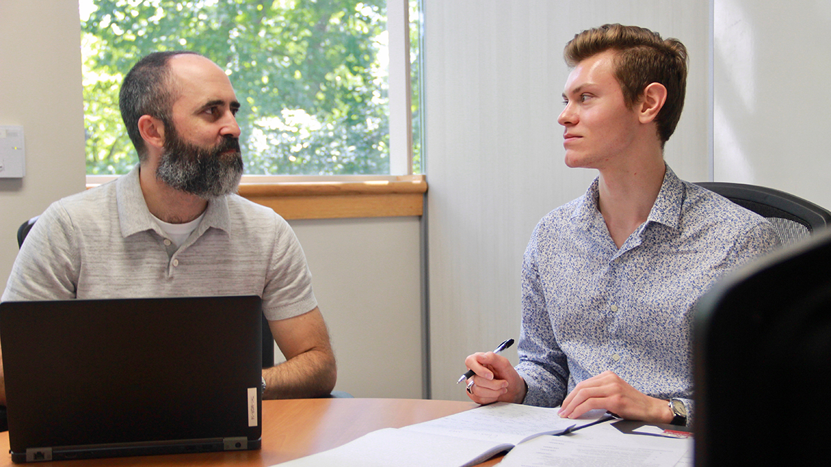 Daniel Bowen (right) meets with Ross Tompkins, assistant to the town manager, to discuss Chapel Hill's sustainability initiative.