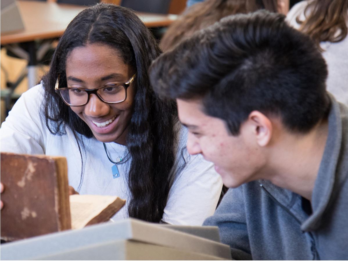 Student's in Jeanne Moskal's English class devoted the spring semester to a daunting assignment: curating a full-scale exhibition in the Wilson Special Collections Library on Frankenstein. An African-American female student and a white male student are shown here poring over materials in Wilson Library.