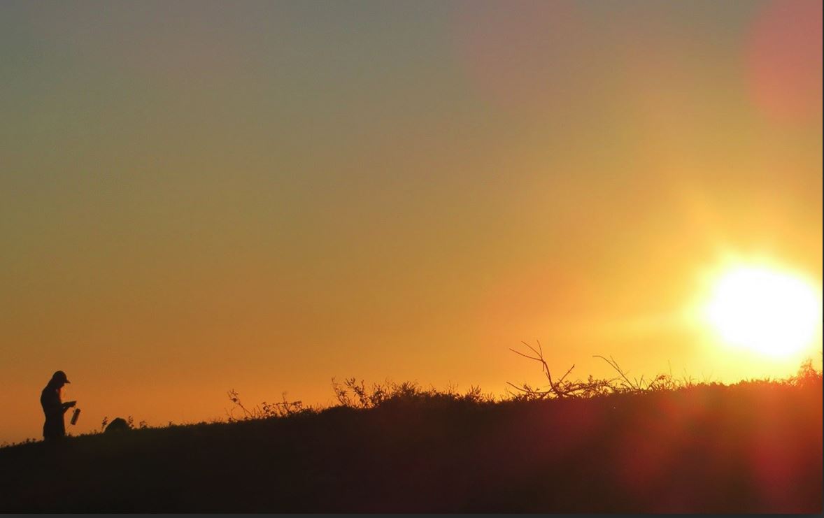 Haley Moser collects data as the sun sets over San Cristobal Island. (photo courtesy of Haley Moser)