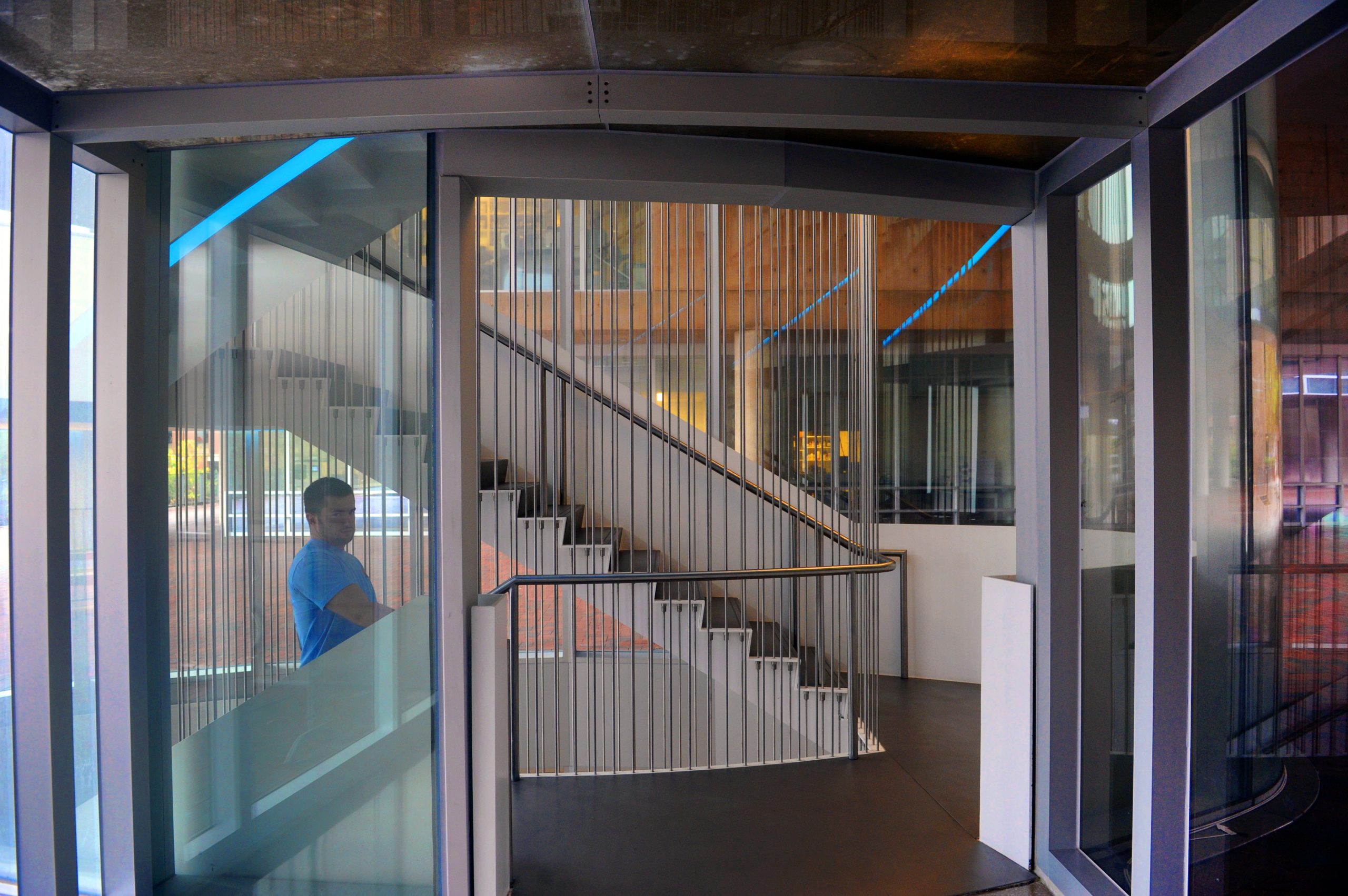 A man walks up a spiral staircase inside the Genome Sciences Building. (photo by Donn Young)