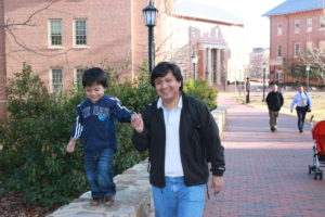 Fredy Grefa with his son, Yutzu, walking on the UNC campus.