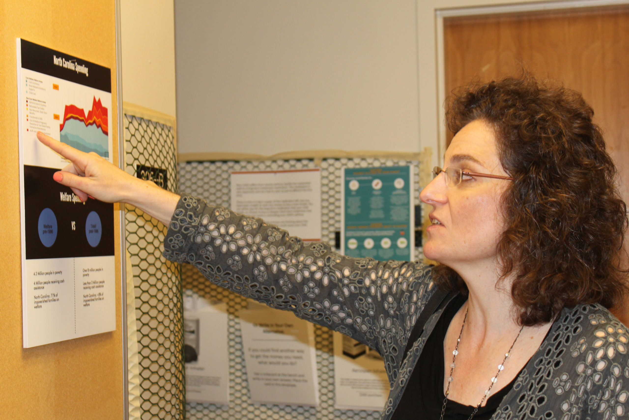 Anthropology associate professor Michele Rivkin-Fish describes one of the panels in the interactive exhibit.