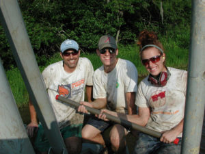 From left, Tony Rodriguez, Robin Matthues and Emily Elliott collect cores in Albemarle Sound. (Photo courtesy of UNC Institute of Marine Sciences)