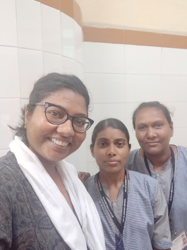 Pallavi Gupta (left) interviews women on the cleaning staff in a waiting hall washroom at a railway station. 