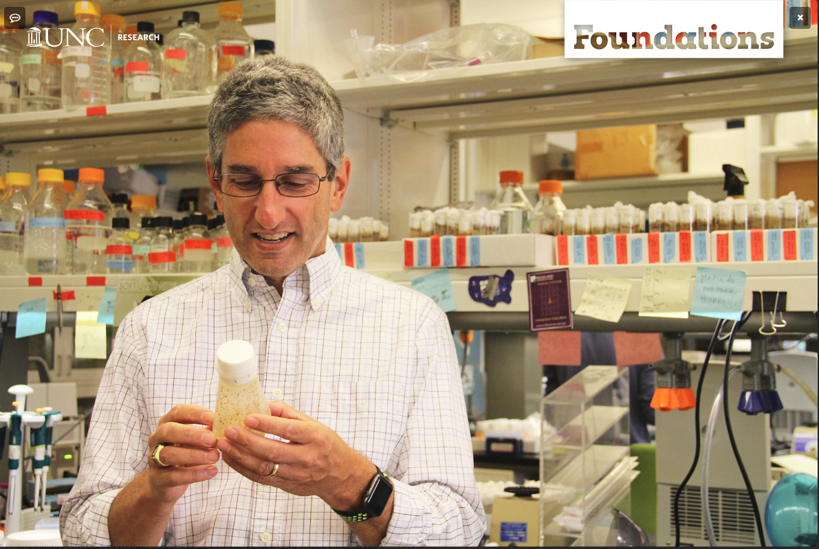  UNC geneticist Bob Duronio is one of those scientists who studies fruit flies. He is holding a vial of fruit flies.