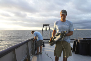 UNC researchers Scott Gifford and Adrian Marchetti take water samples off the Galapagos Islands in 2015. (photo by Mary Lide Parker)