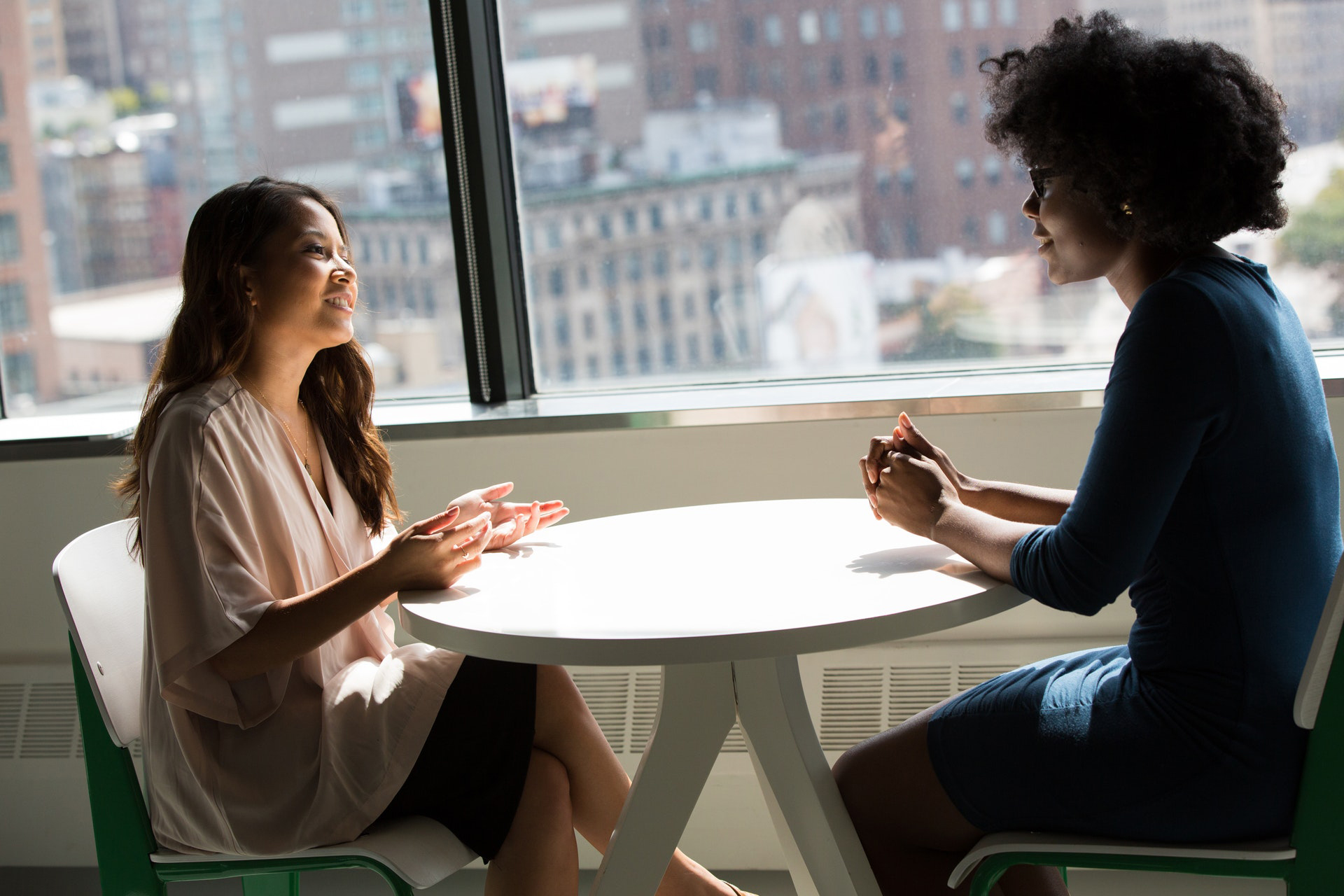 hotography-of-women-talking-to-each-other across a table