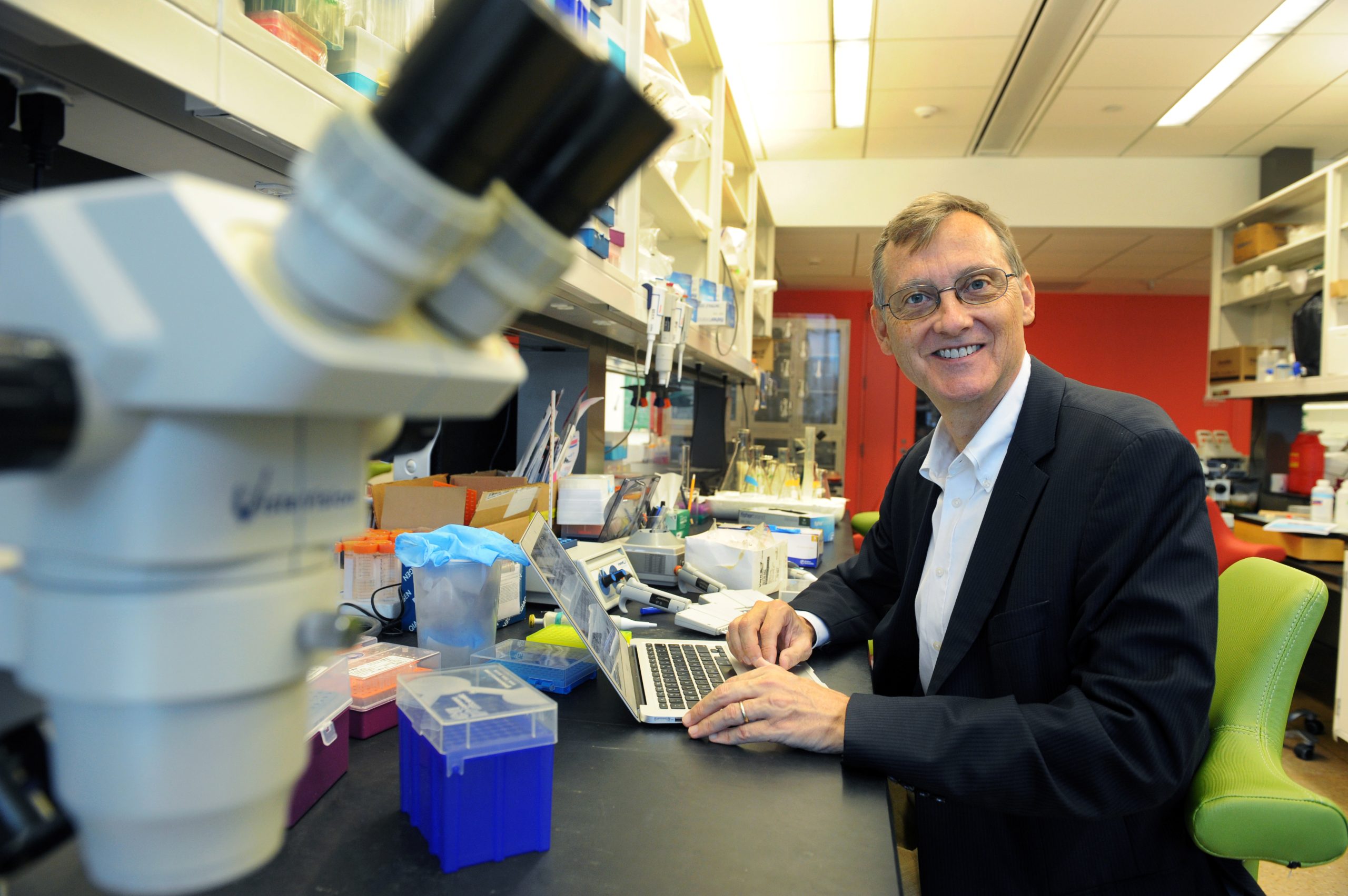 Caleb King (pictured in a Genome Sciences Building lab) will lead the Institute for Convergent Science. (photo by Donn Young)