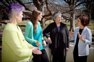 From left, recipients of the University Award for the Advancement of Women Award -- Karen Booth, Audrey Rose Verde and Donna Bickford -- are congratulated by Chancellor Carol L. Folt, far right.