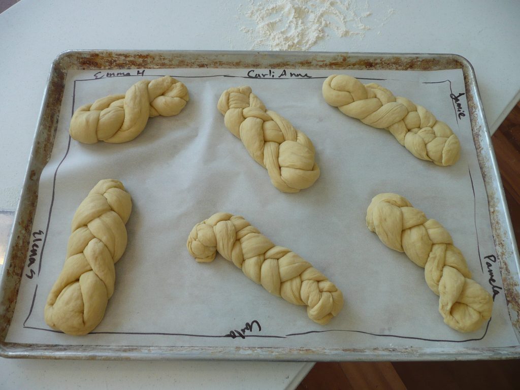 Challah braided by study tour participants awaits baking.