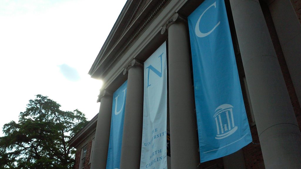 UNC banners on the face of South building.