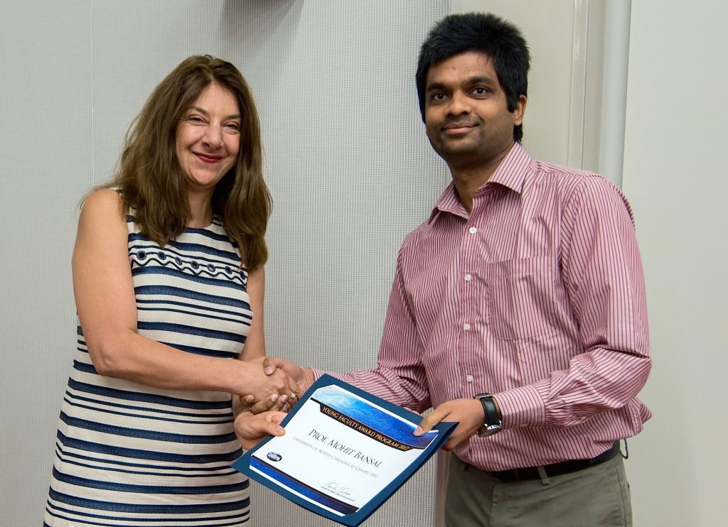Assistant Professor Mohit Bansal (right) receives the DARPA Young Faculty Award certificate from DARPA Program Manager Fariba Fahroo.