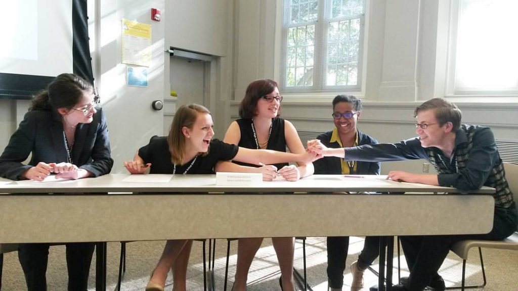 The Parr Center for Ethics has received a $10,000 diversity and inclusiveness grant from the American Philosophical Association to support the National High School Ethics Bowl. (Photo shows students discussing a case sitting at a table)