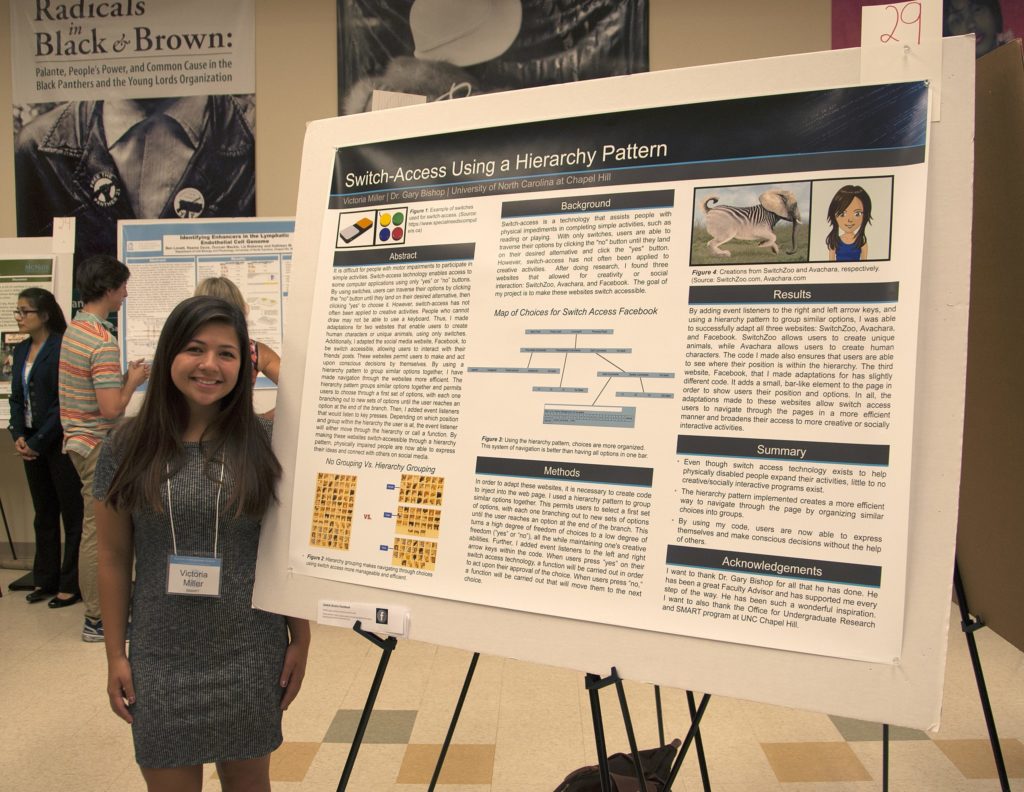 Victoria Miller stands in front of a poster about her research.
