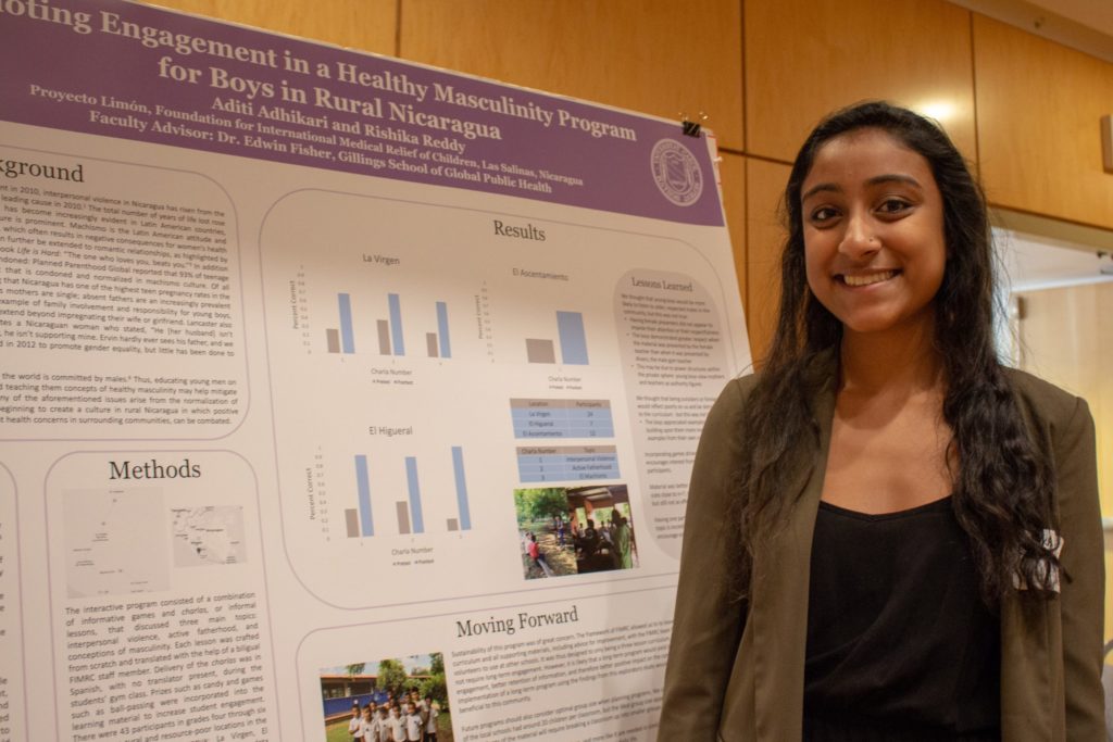 Public policy major Aditi Adhikari stands in front of her poster, "Promoting Engagement in a Healthy Masculinity Program for Boys in Rural Nicaragua"