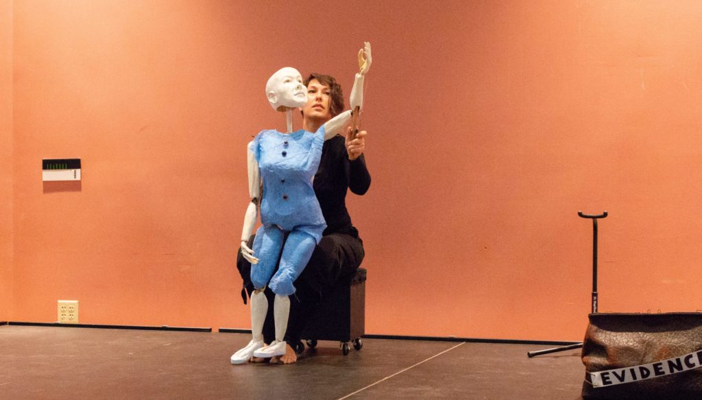 Artist Marina Tsaplina performs on stage with her puppet.