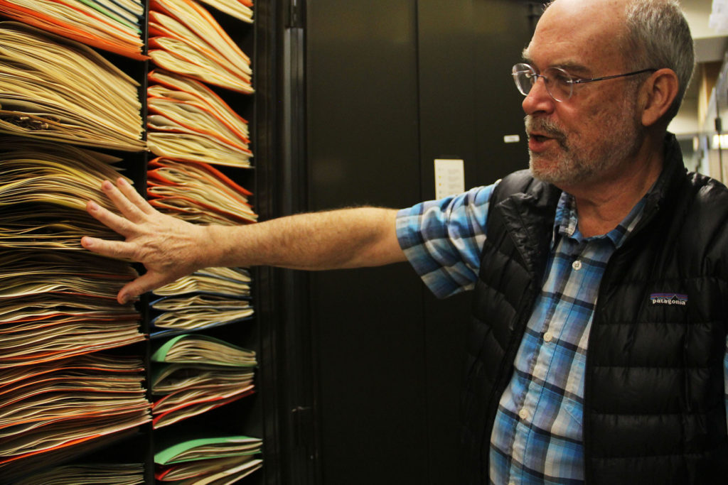 Alan Weakley shows off the storage system at the UNC Herbarium. Founded in 1908 by William Chambers Coker, it resides on the top floor of Coker Hall and is the largest in the Southeast. In 2000, it became part of the North Carolina Botanical Garden. Specimens are kept within folders inside large, green cabinets that litter the various floors of the building. (photo courtesy of Endeavors)
