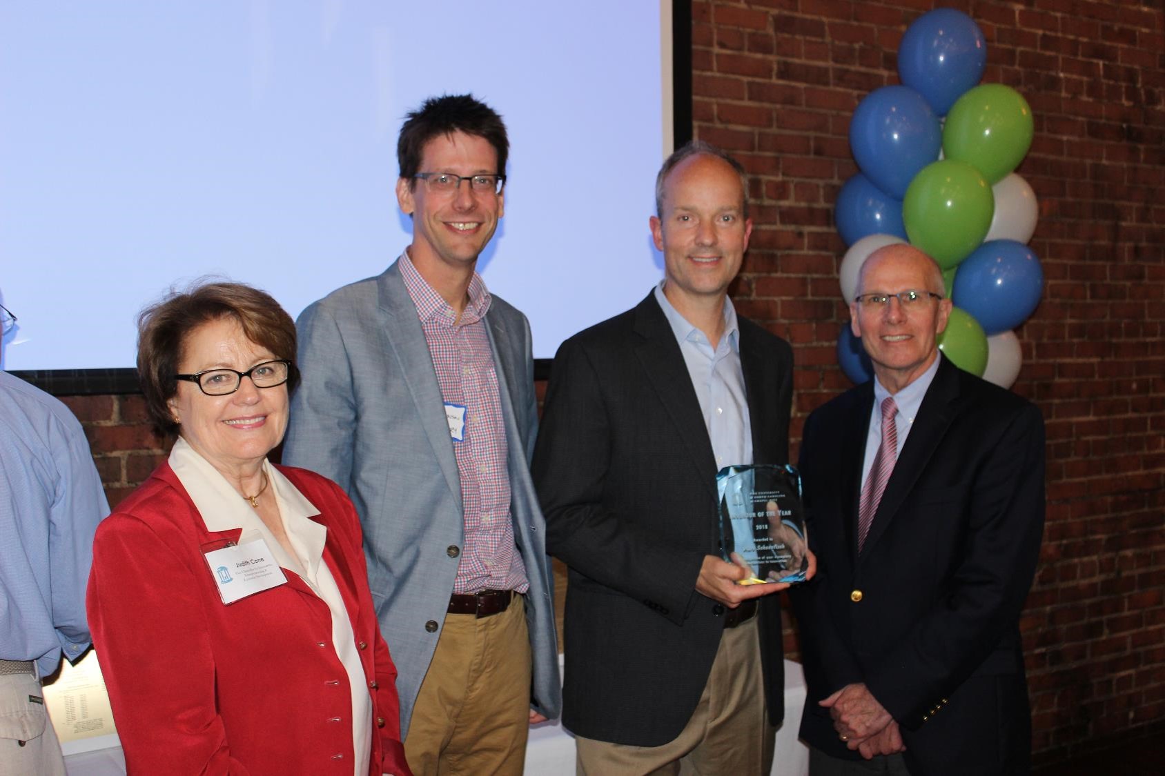 Mark Schoenfisch, professor of chemistry (third from left) holds the UNC Inventor of the Year Award. Also pictured: Judith Cone, vice chancellor for innovation, entrepreneurship and economic development (left); Jeff Johnson, A. Ronald Gallant Distinguished Professor and chair, UNC Department of Chemistry (second from left); and Bob Blouin, executive vice chancellor and provost (right)