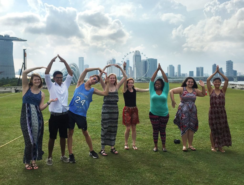 Exchange students spell out C-A-R-O-L-I-N-A in front of the Singapore skyline in summer 2015.