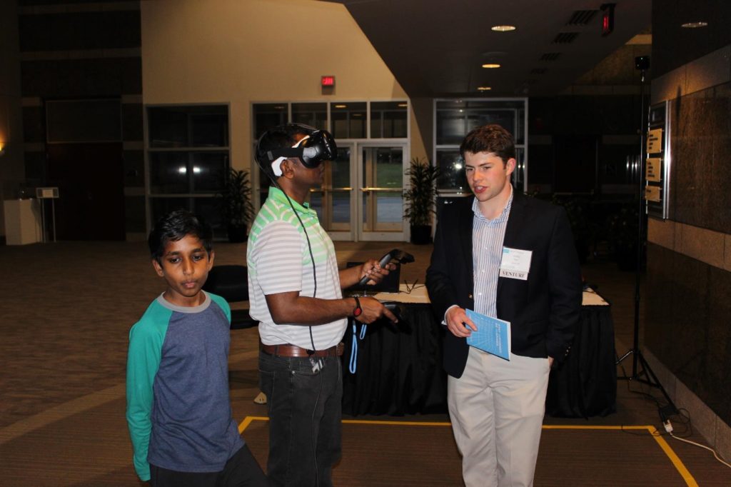 UNC student Grady Hale (right) demos the Brain VR technology at the 2018 UNC Innovation Showcase.