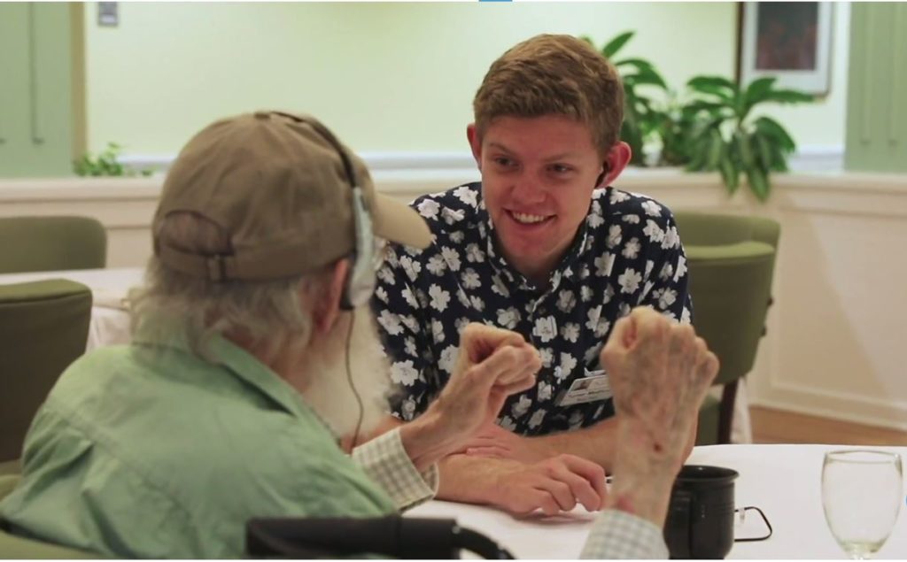 Turner Medicott (right) talks with a resident of Carolina Meadows about music.