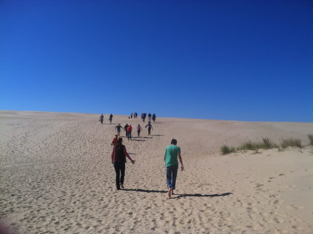 Students walk across the sand at the Outer Banks Field Site.