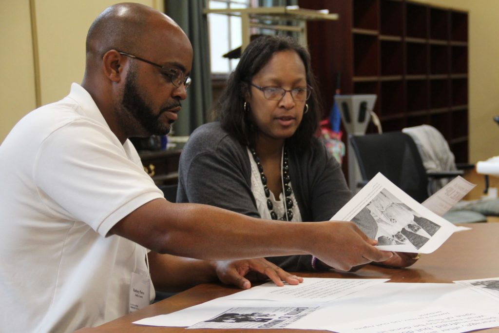 North Carolina teachers Rodney Pierce and Rebecca McKnight sift through artifacts from the Civil Rights Movement during an activity at the 2018 Carolina Oral History Fellowship. (photo courtesy of Endeavors magazine)