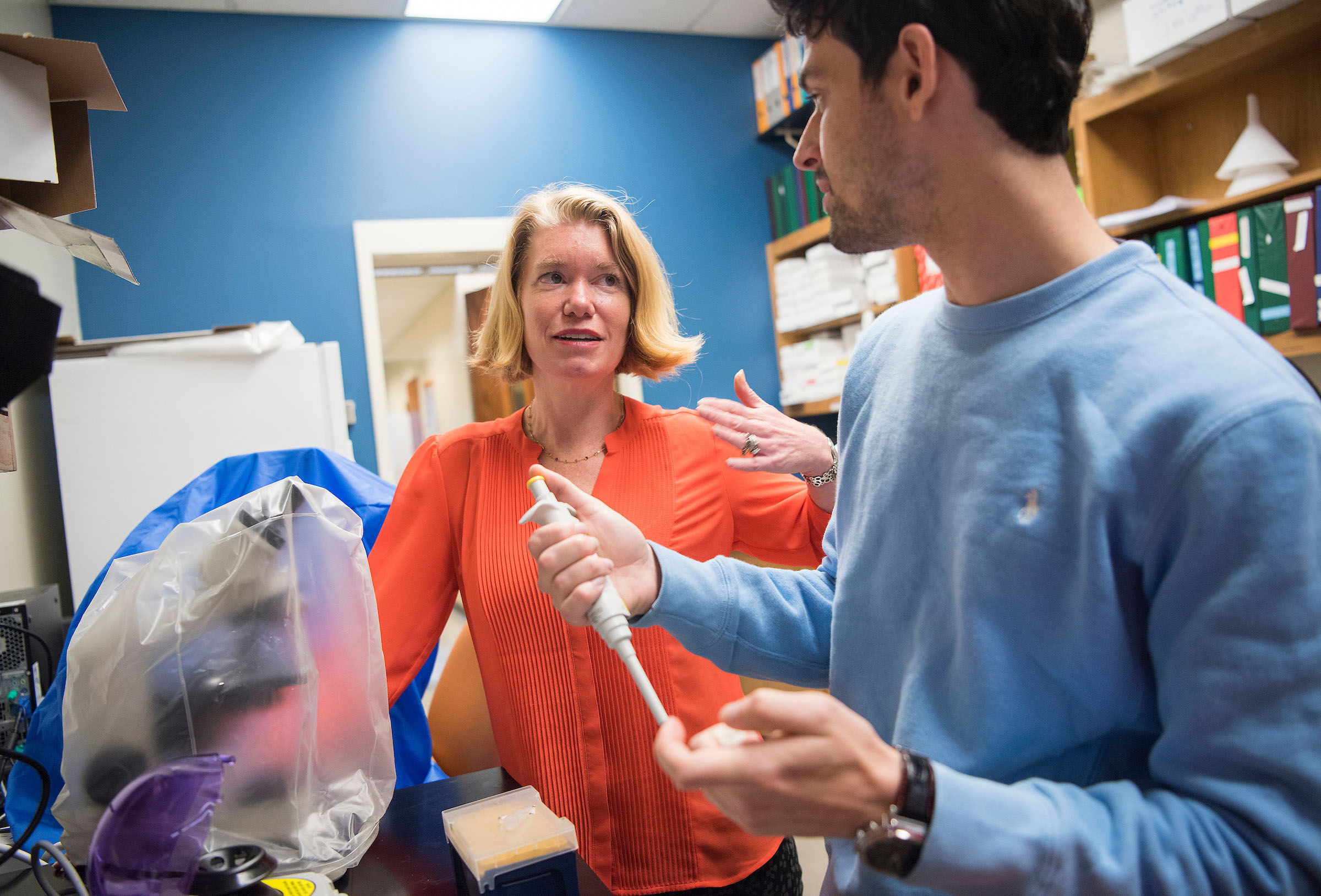 Amy Gladfelter (left) received a "big ideas" grant from the National Science Foundation to support interdisciplinary research. (photo by Jon Gardiner) She is pictured in a lab setting with one of her students.