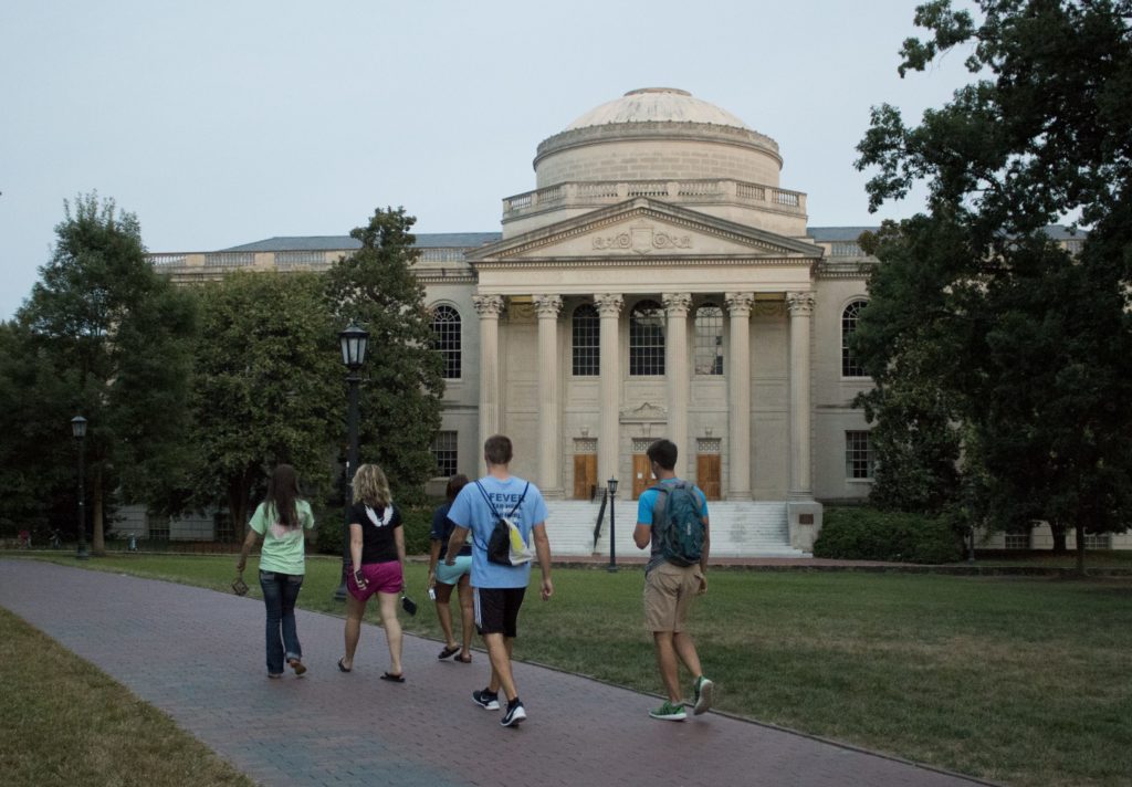 Students walk by Wilson library in the early evening.