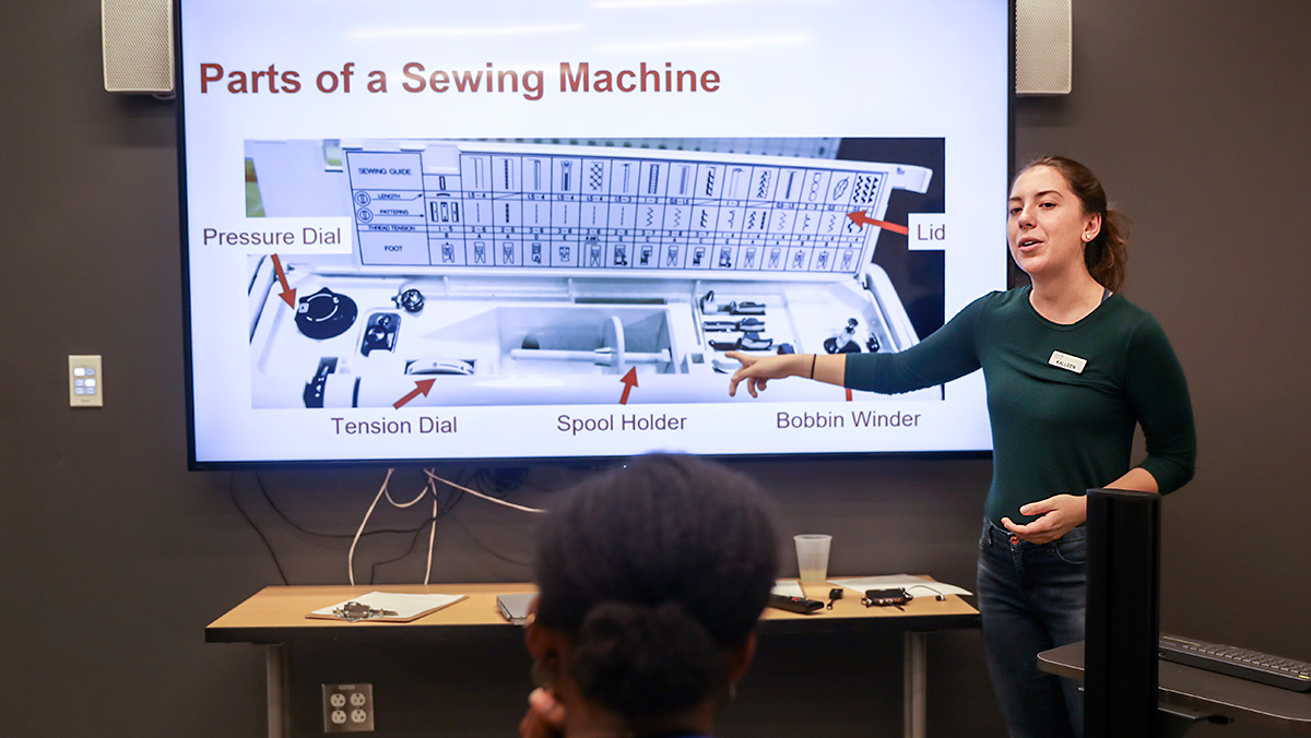 Kelley teaching about the sewing machine
