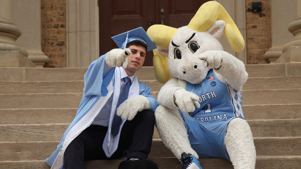 Alex Floch sits on the steps of South Building with Rameses in 2017. (Photo by Kimberly Rivers.)