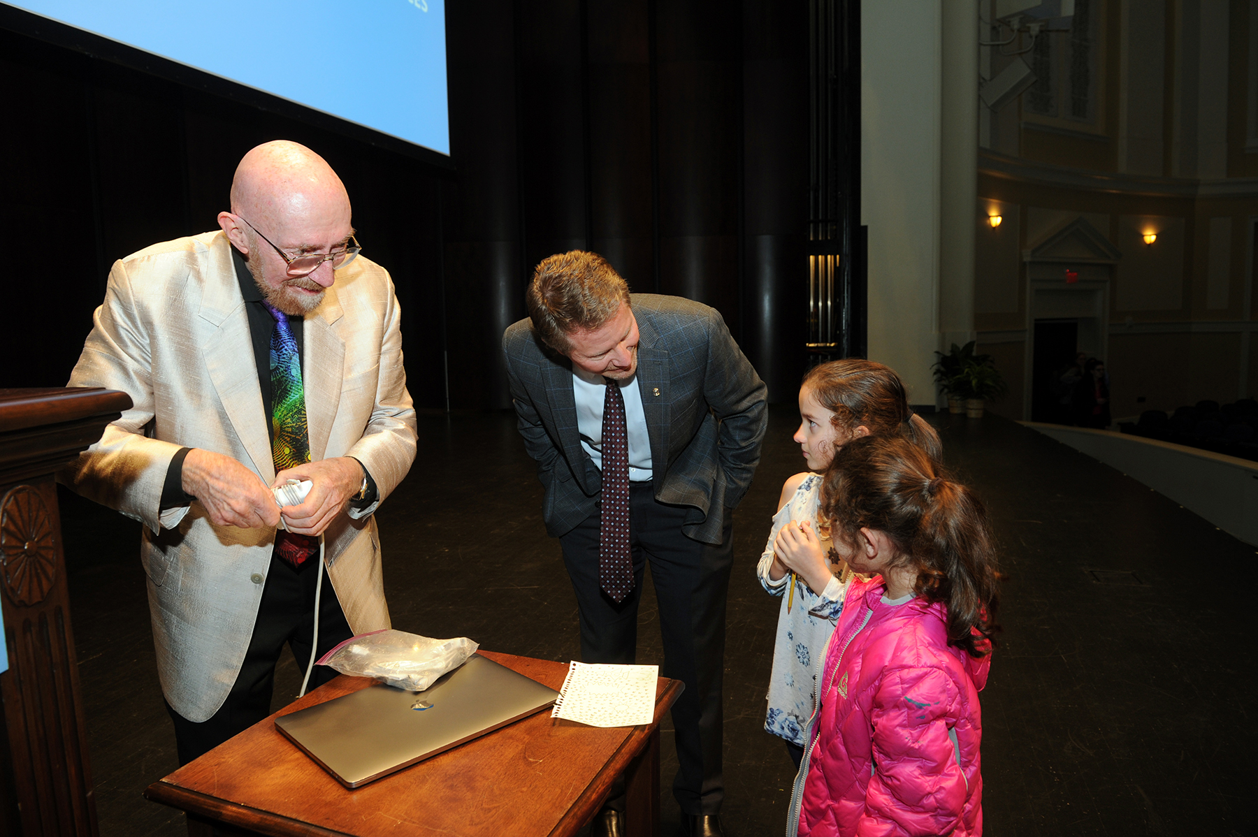 Thorne (left) and Interim Chancellor Kevin M. Guskiewicz talk with young attendees after the talk. (photo by Donn Youn
