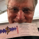 Bill Ferris holding Grammy ticket in his mouth