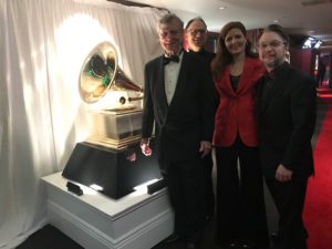 Bill and Dust-to-Digital collaborators stand in front of large Grammy statue.