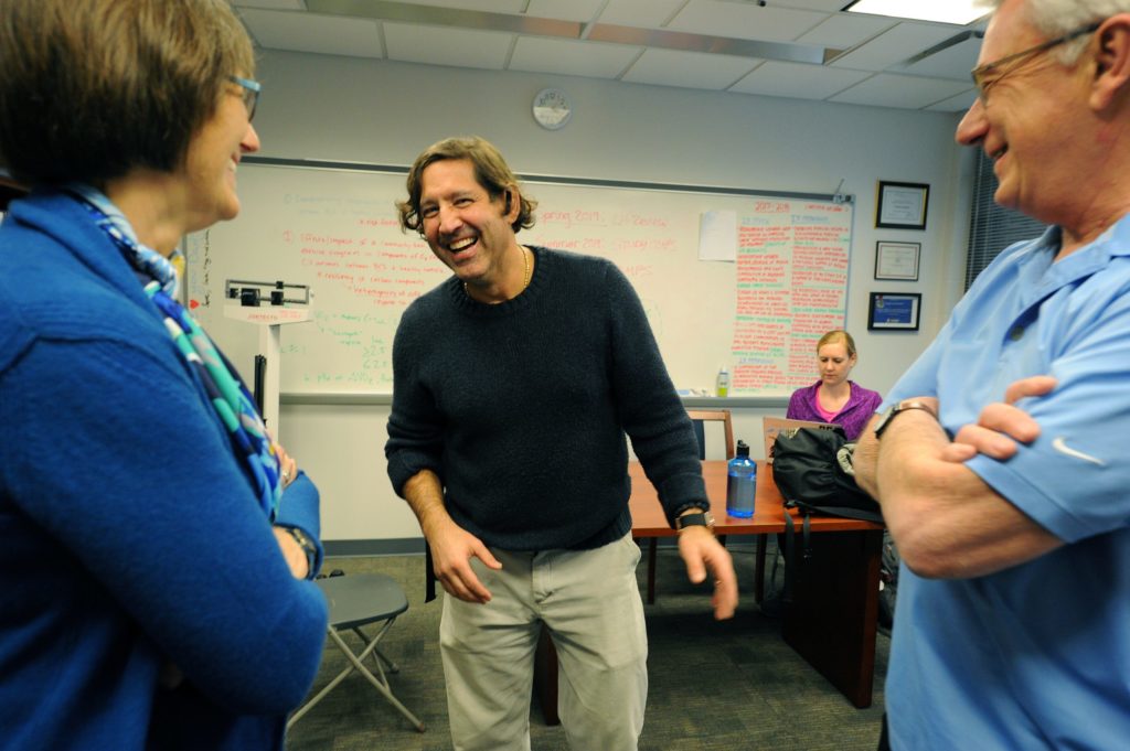 From left, Barbara Fredrickson, Claudio Battaglini and Arne Kalleberg share a laugh after class. They teach the Triple I course, "Health and Happiness." (photo by Donn Young)