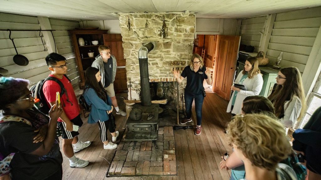 UNC students tour the Duke Homestead State Historic Site and Tobacco Museum as a part of their museum studies course taught by Associate Professor Lyneise Williams on May 23, 2019, in Durham, North Carolina. In this image, historic interpreter Brooke Csuka (center) leads the tour. Csuka is also second-year master's of library science student in the UNC School of Information and Library Science. (Johnny Andrews/UNC-Chapel Hill)