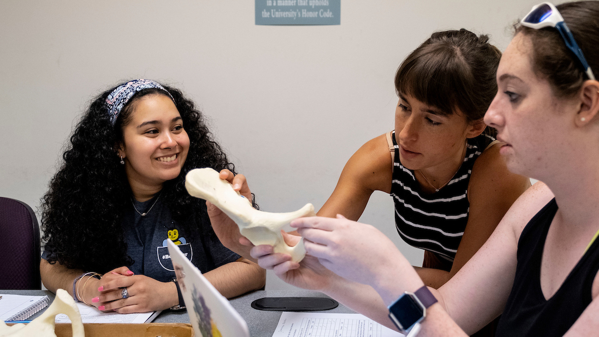 Glamar Galeas (left) and Dominique Reardon (right) work with teaching assistant, Stephanie Berger during the Maymester course, Written in Bone: Exploring the science of death investigation. Anthropology Professor Dale Hutchinson teaches students from all majors how to map and recover the elements of a crime scene in his class.(Jon Gardiner/UNC-Chapel Hill)