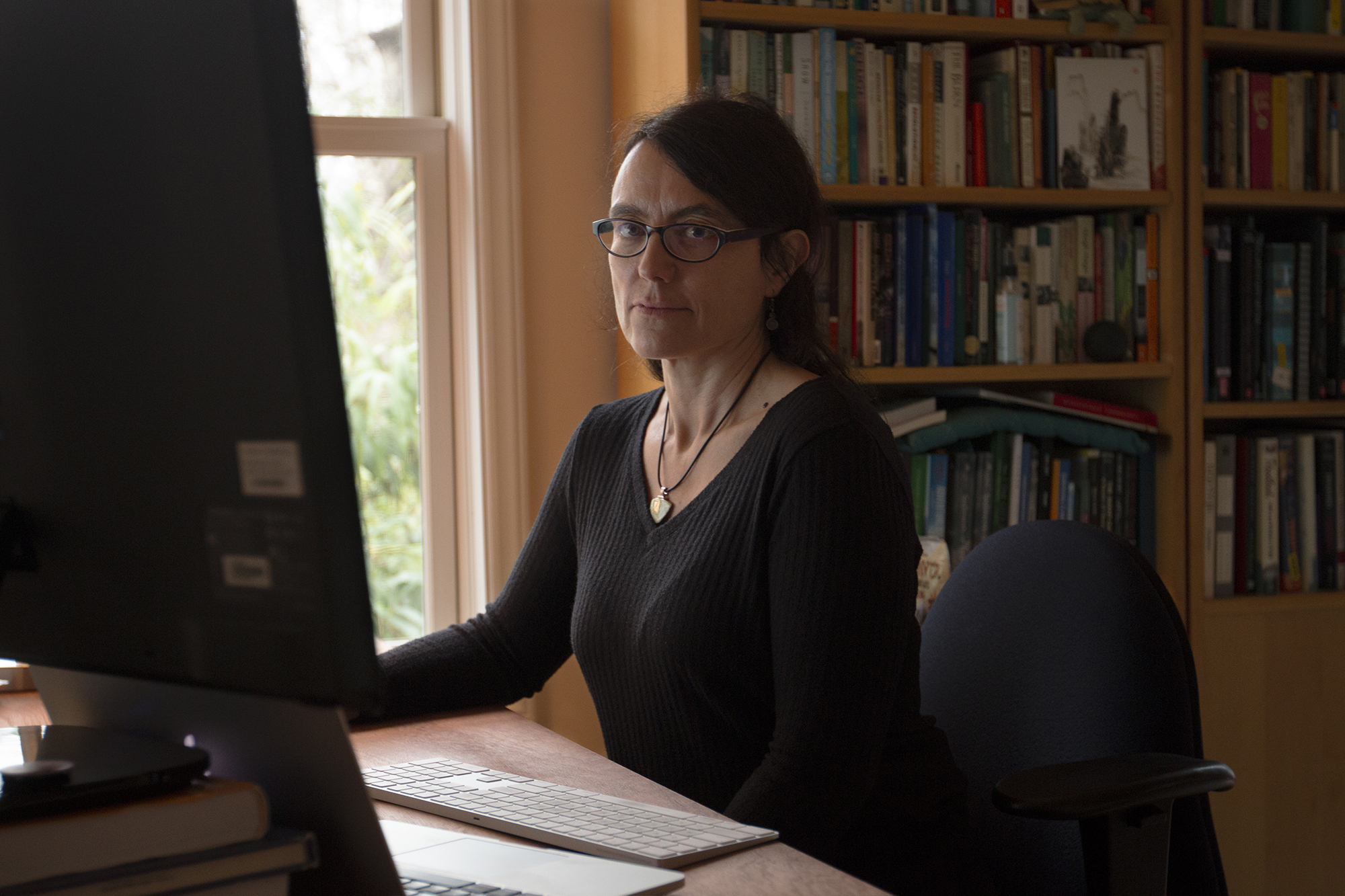 Julia Haslett, a documentary filmmaker and assistant professor of communication, edits her films in her home office in Carrboro, North Carolina. (photo by Alyssa LaFaro)