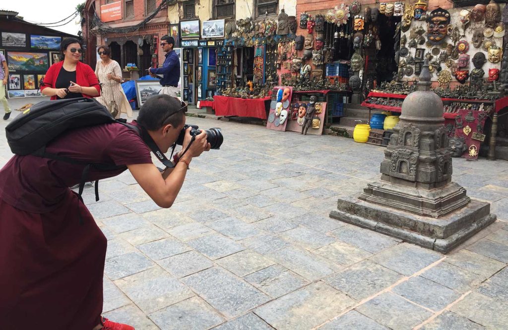 A red-robed monk practices photogrammetry techniques in Nepal. (photo by Lauren Leve)
